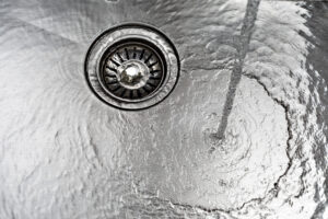 water drains down a stainless steel sink 2026 01 07 07 12 41 utc