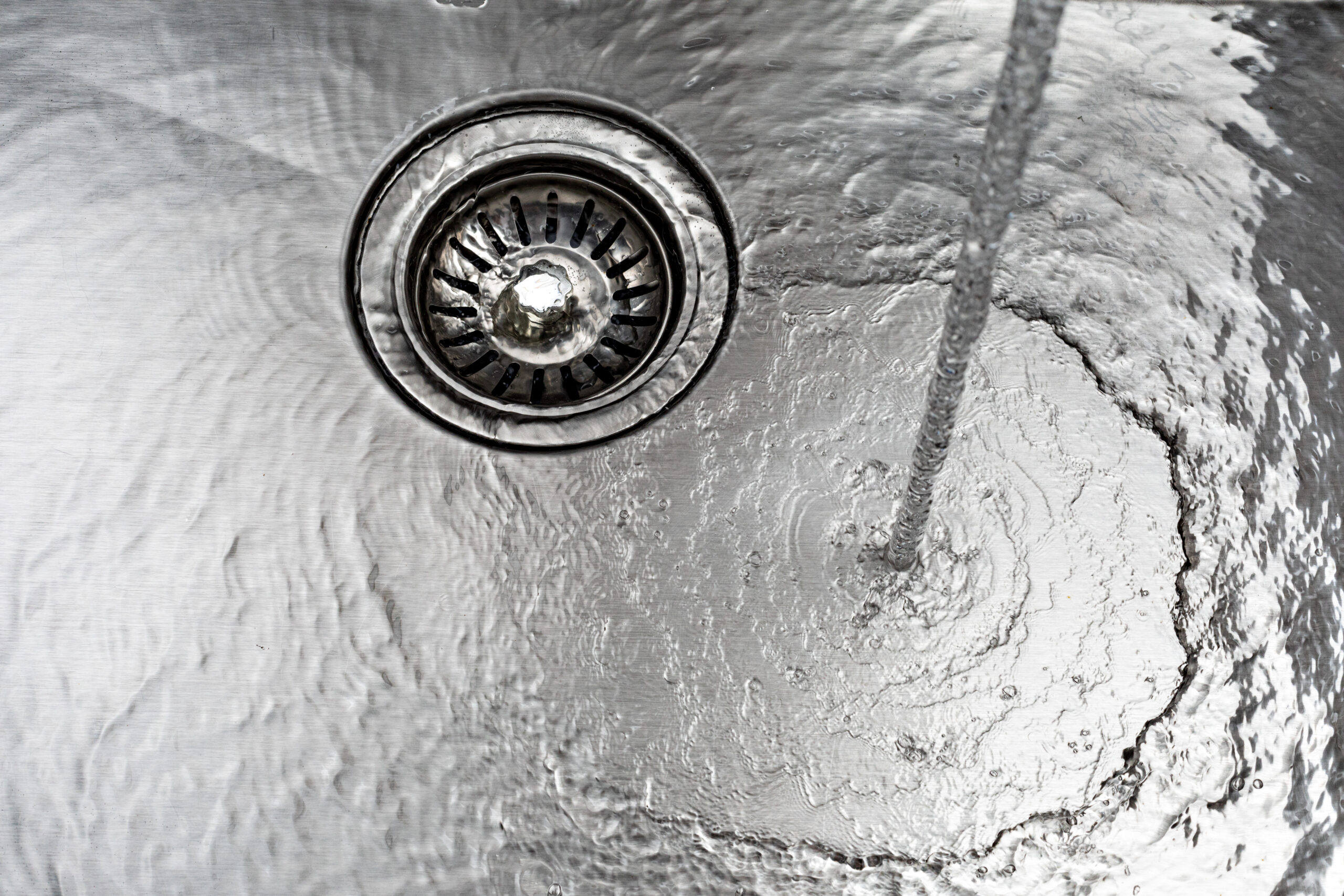 water drains down a stainless steel sink 2026 01 07 07 12 41 utc