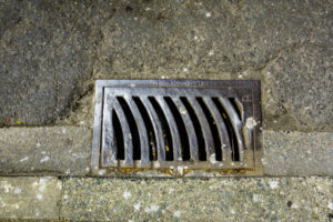 storm drain on a roadway a metal grille 2026 01 09 09 10 16 utc