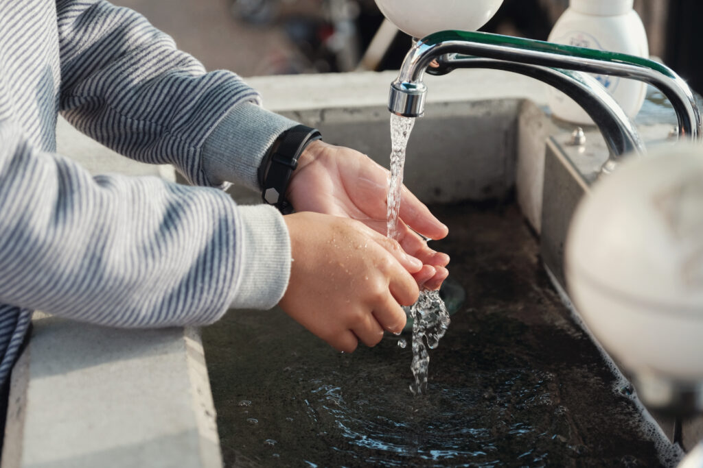 young boy washing his hands in the sink 2026 03 10 01 00 01 utc